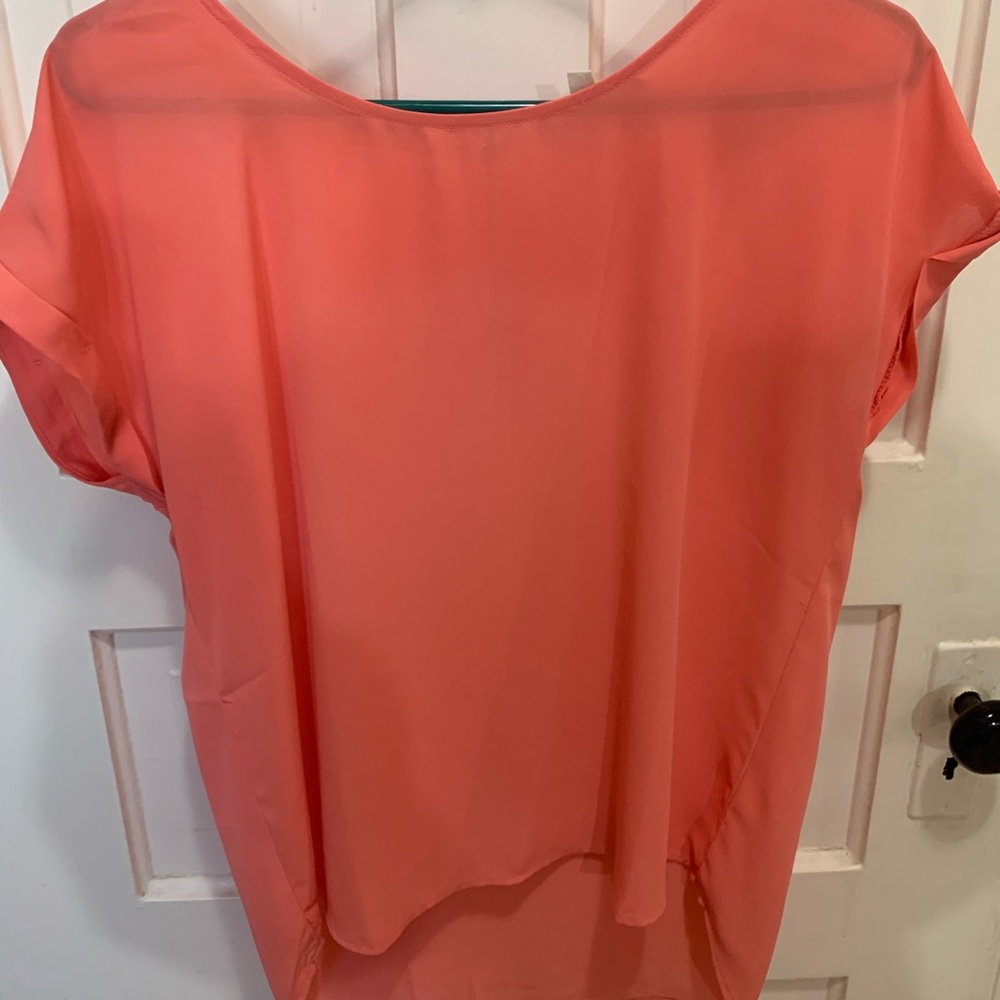 Sheer pink blouse.